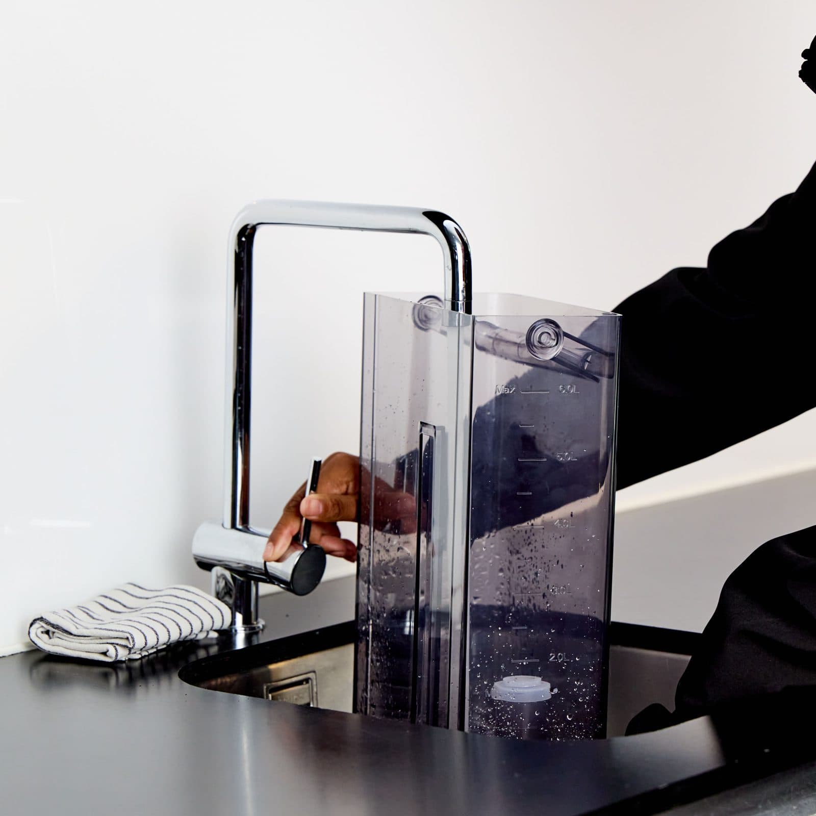 Filling the removable tank at the kitchen tap